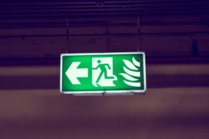 Illuminated emergency light suspended from ceiling