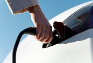 a person plugging in an electric vehicle charger