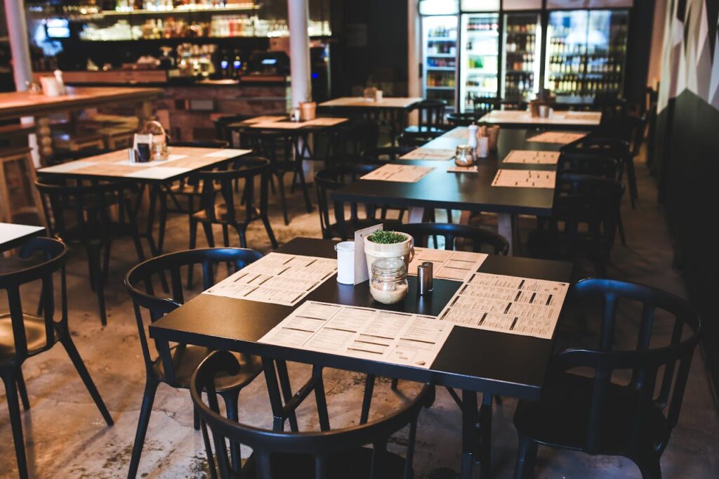 restaurant with black tables and fridges