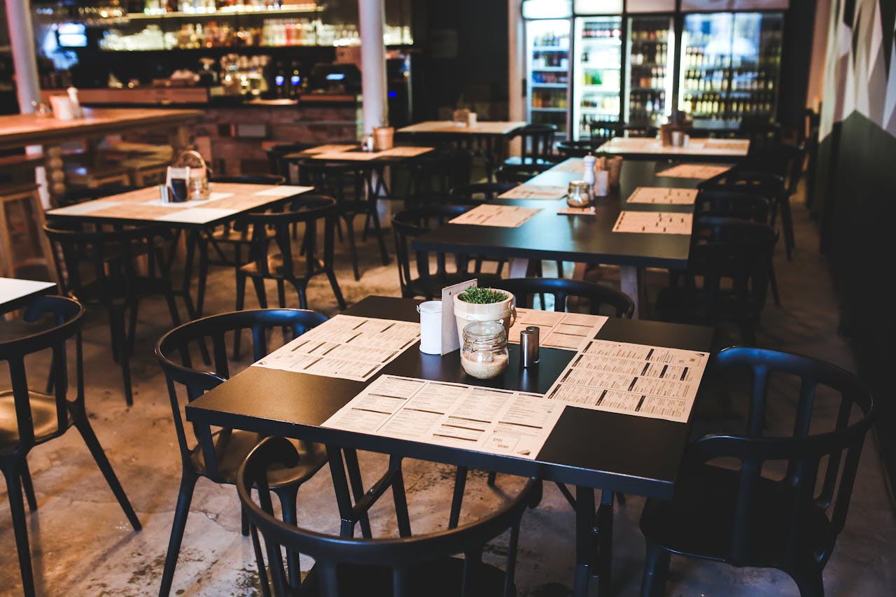 restaurant with black tables and fridges