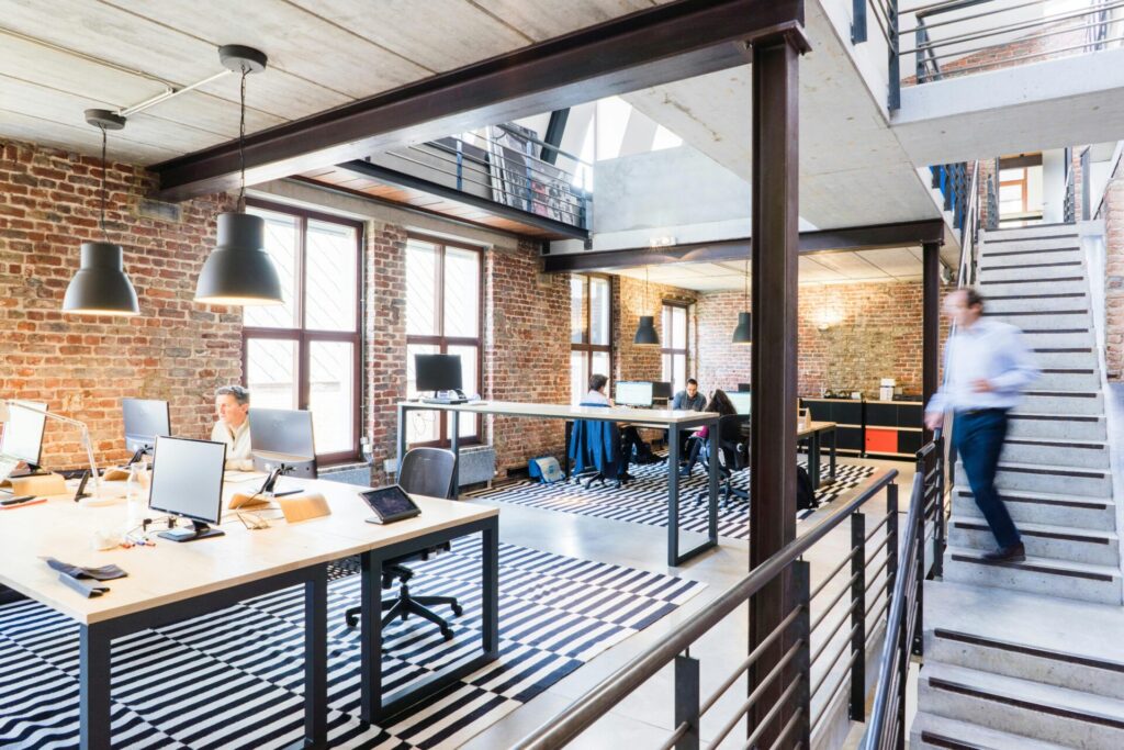 man walking down the stairs in an office