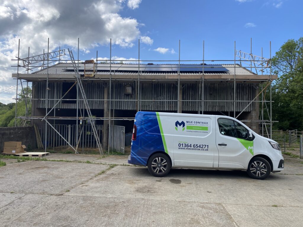 M&E van in front of building with solar panels on roof