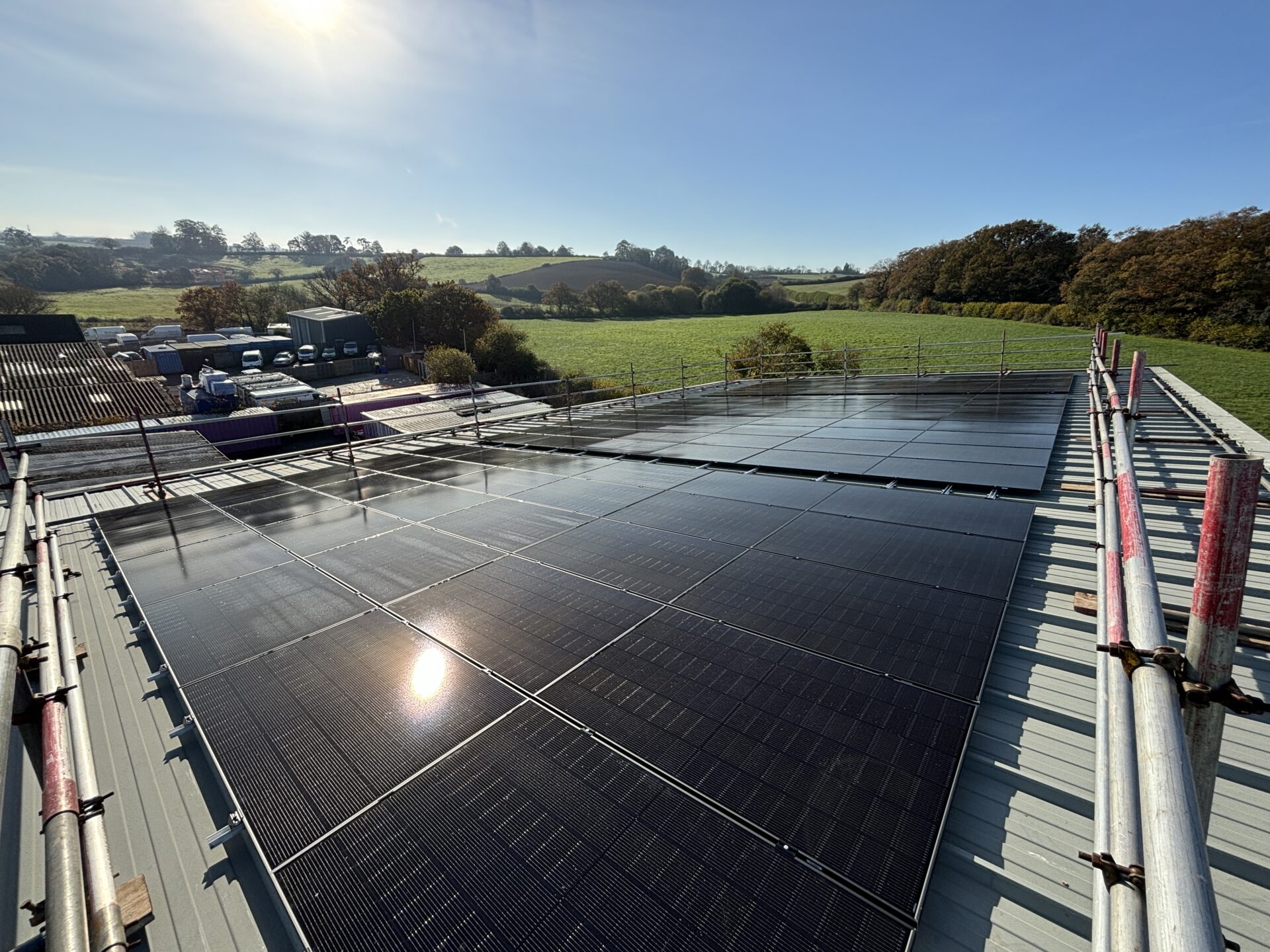 solar panels flat on roof with sun shining