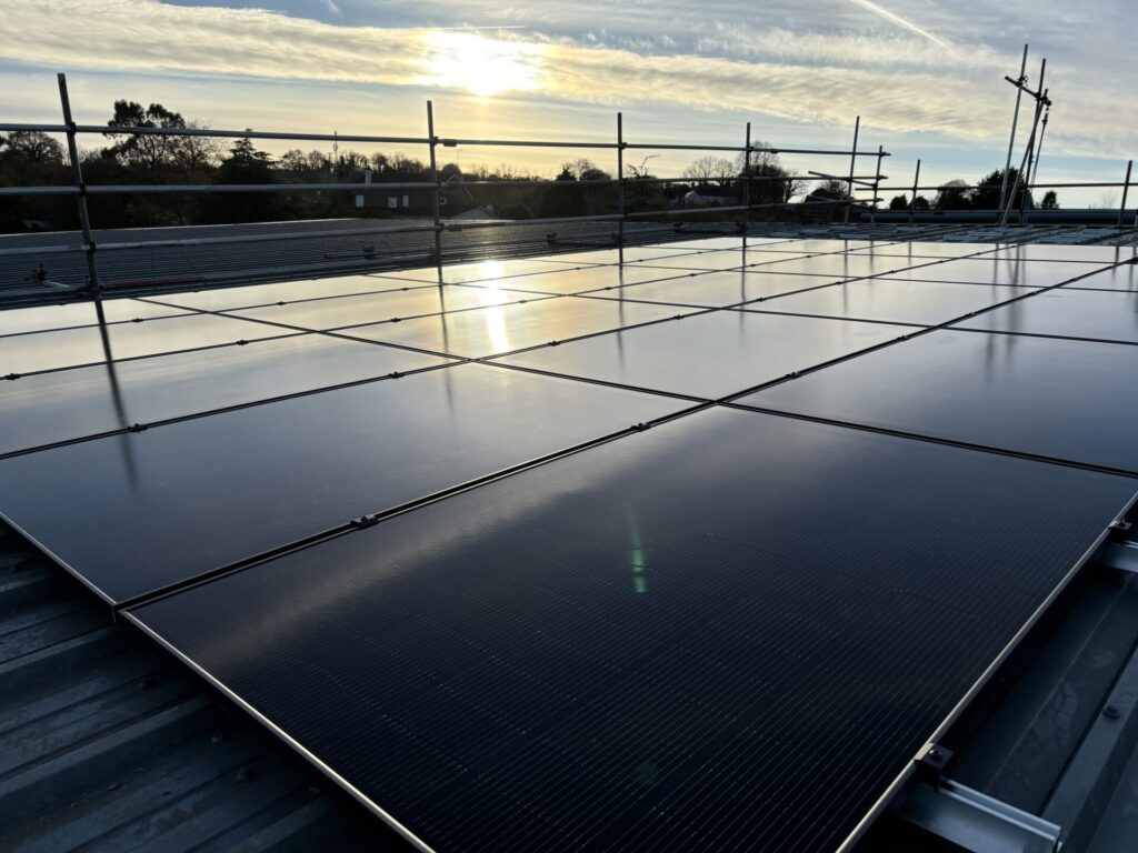 solar panels with rails and sun in background