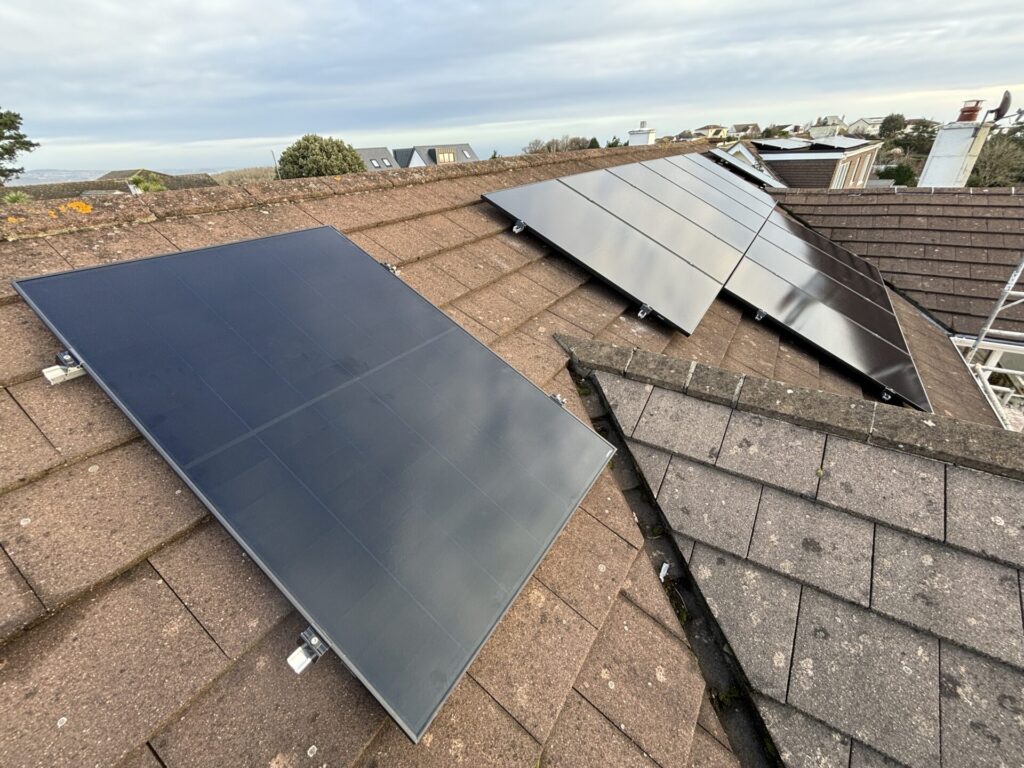 single solar panel next to formation on roof