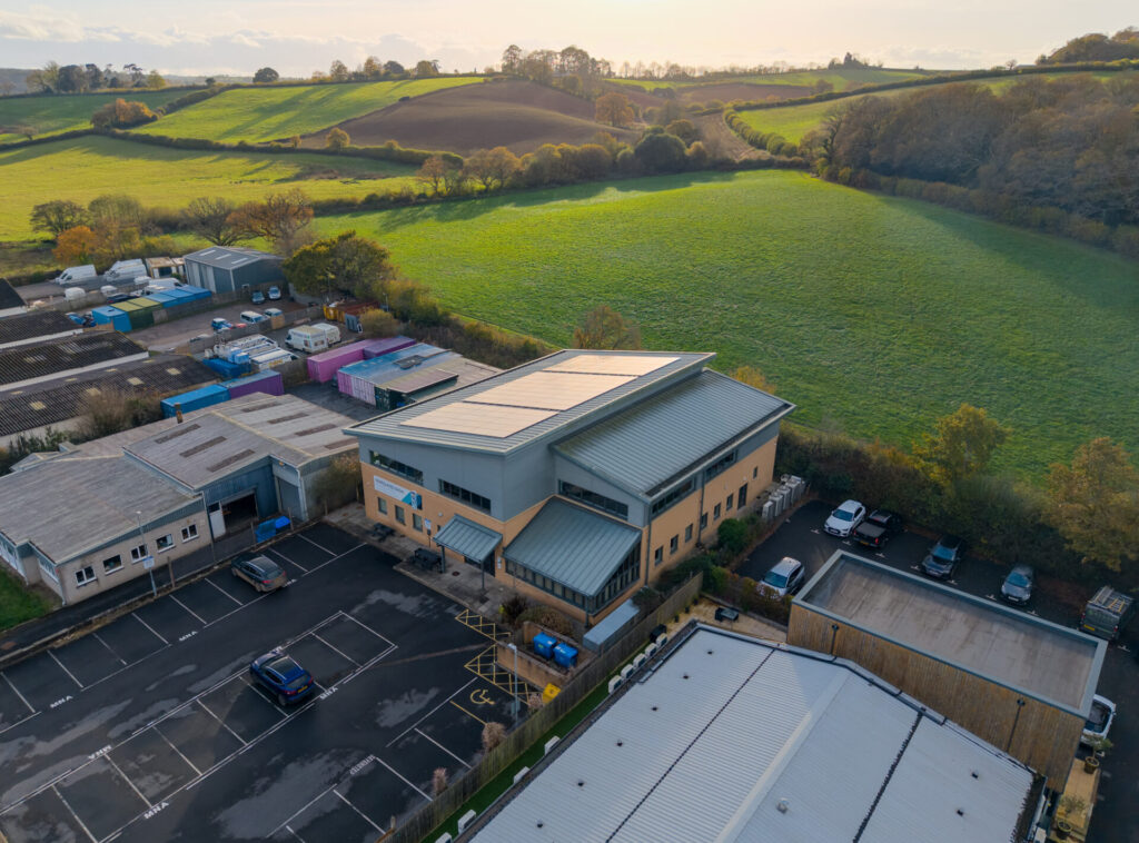 new solar installation on top of commercial roof in countryside